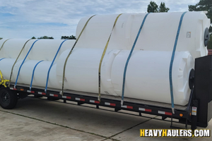 6 – 500 gallon and a 10 – 200 gallon vertical tanks hauled on a hotshot trailer.