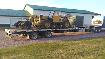 Telescopic handler shipped on a drop deck trailer.