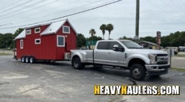 Tiny home transported by a pickup truck.