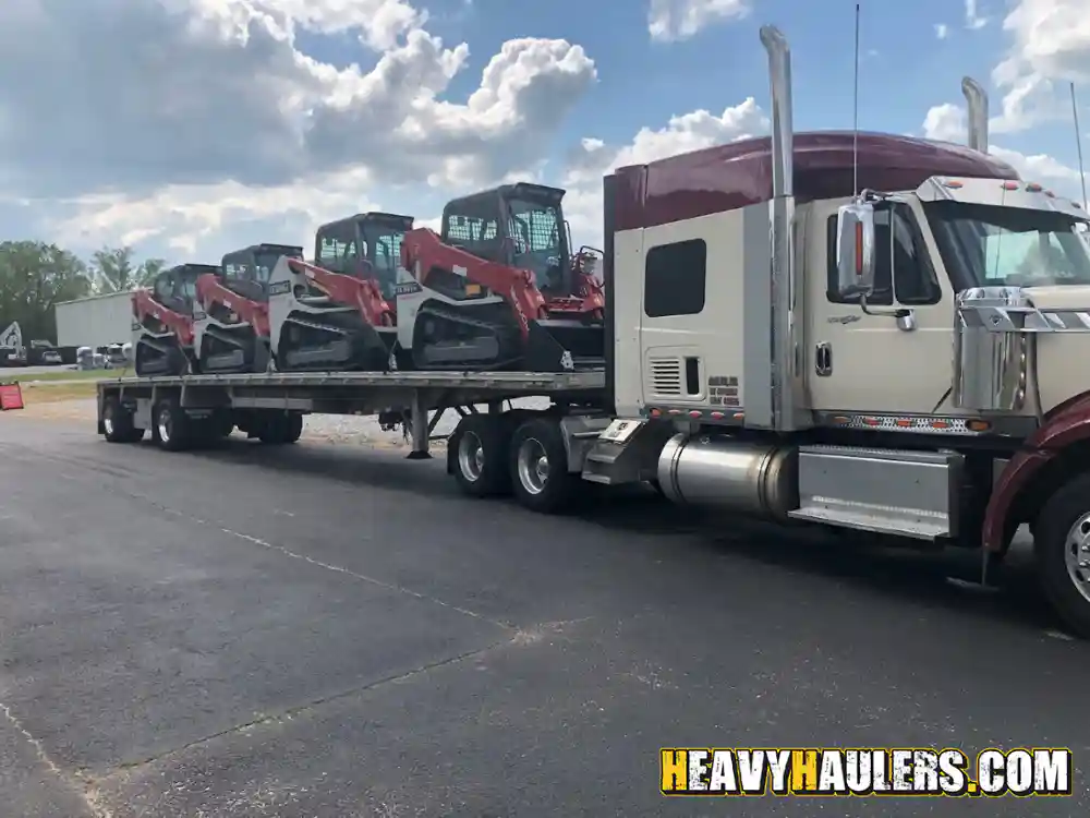 Towing multiple takeuchi loaders on a flatbed trailer