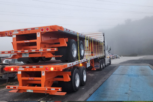 Hauling double stacked flatbed trailers.