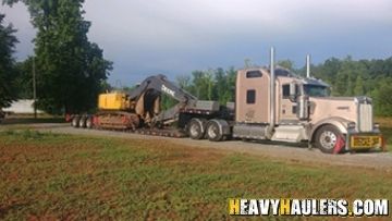 Shipping John Deere equipment on an RGN trailer.