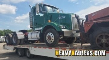 Hauling 2 Kenworth daycabs.