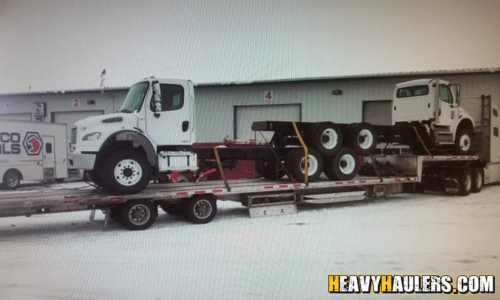 Hauling two 2008 Freightliner M2 cab chassis trucks.