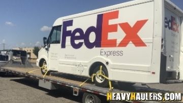 Box truck shipped on a flatbed trailer.