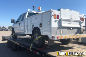 Loading a 2013 ford f350 service truck on a trailer.