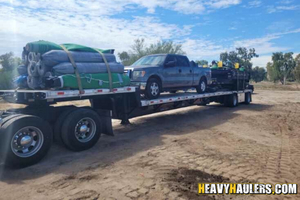 Ford F150 and big tex trailer with 2 sandtrap rake transport.