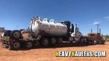 Kenworth vacuum truck transport.