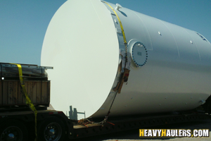 An oversize tank loaded on a trailer.