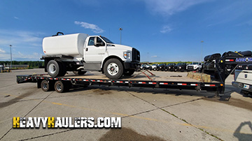 A water truck being transported