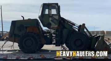 Loading a Case wheel loader on a trailer for transport.