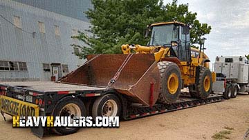 Hauling a 2011 Caterpillar 966H wheel loader.