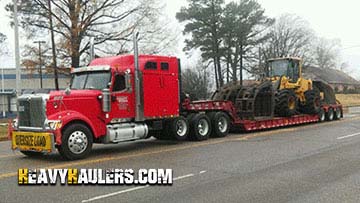 Loading a Caterpillar wheel loader on a trailer.