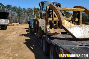 Hauling a John Deere 724k wheel loader.