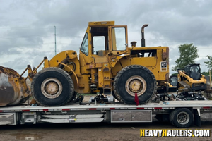 Hauling a 1979 Caterpillar 966C wheel loader.