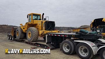 Hauling a Volvo L220E wheel loader.