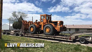 Loading a Volvo L70F wheel loader on a trailer.