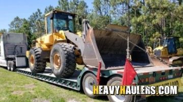 Loading a Volvo wheel loader on a trailer for transport to Ohio.