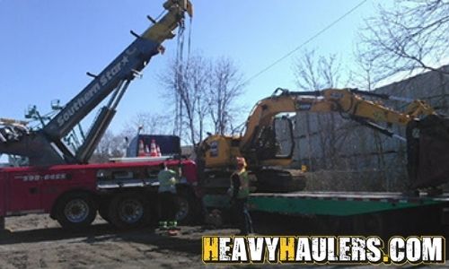 Winch truck loading an excavator