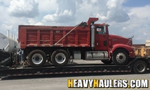 Volvo dump truck shipped on a trailer.