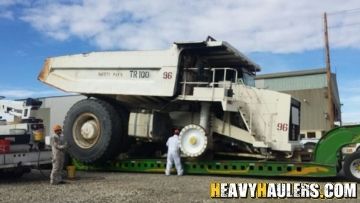Breaking down an oversize rock truck for transport.