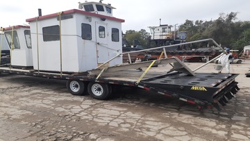 Tugboat pilot houses being transported.